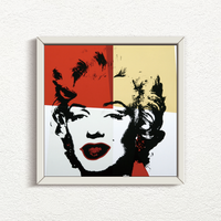 an image of a sunday b morning print after andy warhol titled 'golden marilyn 38' in white frame. the artwork features a black screenprint of marilyn monroe's face overlayed on a background of red, yellow, and white