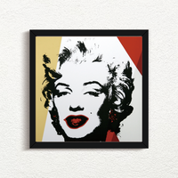 image of an artwork by andy warhol titled 'golden marilyn 37' in a black frame. the artwork features a stencilled image of marilyn monroe's face in black, on a background of white, red, and gold. this is a sunday b morning print