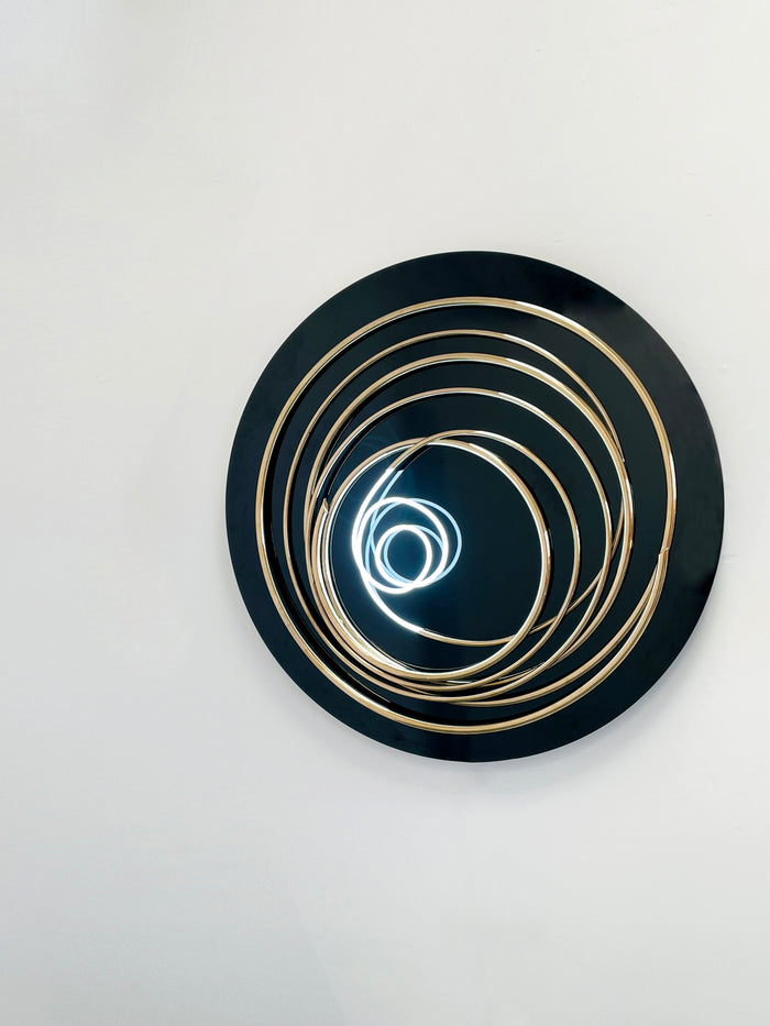 Transform your space with Mark Beattie's White Neon in Gold Spiral, a unique sculpture featuring white neon and 24ct gold plated copper on black acrylic. This one-of-a-kind masterpiece, with a diameter of 120cm, creates a captivating interplay of light, texture, and contemporary design. Illuminate your surroundings with the artistic brilliance of White Neon in Gold Spiral, a unique addition to any collection.