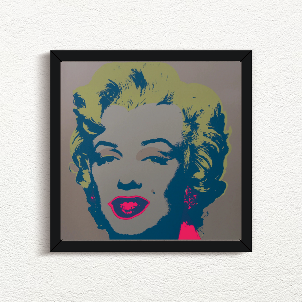 this is an image of a sunday b morning print after andy warhol titled 'marilyn 11:26' in a black frame. the artwork features a screenprint of marilyn monroe's face on a grey background with yellow hair and fuchsia lips with navy blue shadows. this is a sunday b morning print for sale.