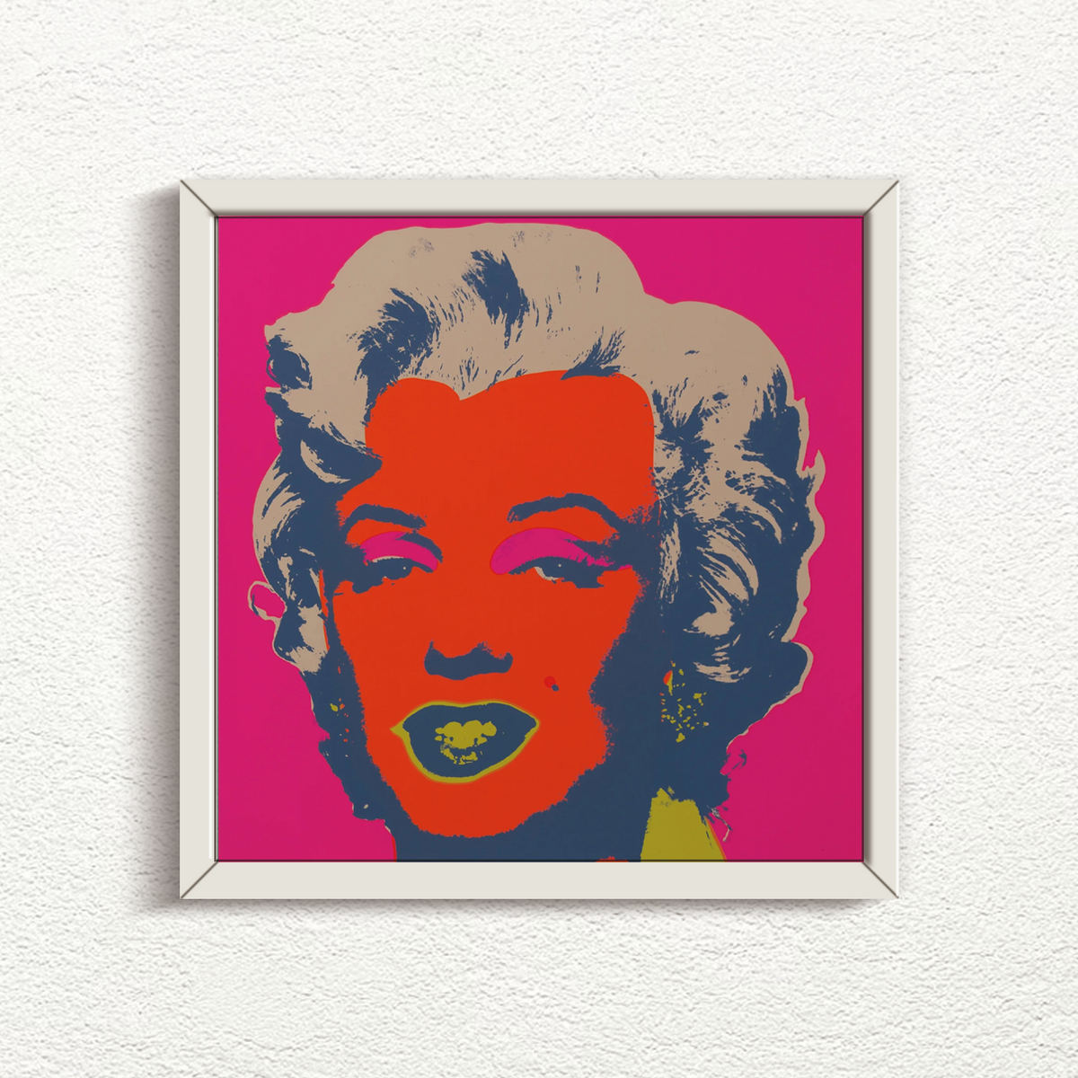 this is an image of a sunday b morning print after andy warhol, titled 'marilyn 11:22' in a white frame. the artwork features a screenprint of marilyn monroe's face in red, navy blue, yellow and beige on a hot pink background. this is a sunday b morning marilyn monroe print for sale