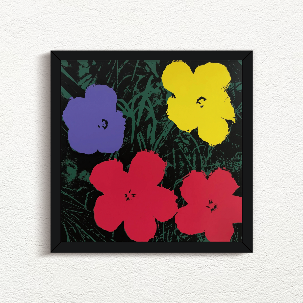 this is an image of a sunday b morning print after andy warhol artwork titled 'flowers 11:73' in a black frame. the artwork features four flowers atop a grassy background. the background is green and black, with the flowers in blue, yellow, and red. this is a sunday b morning print for sale