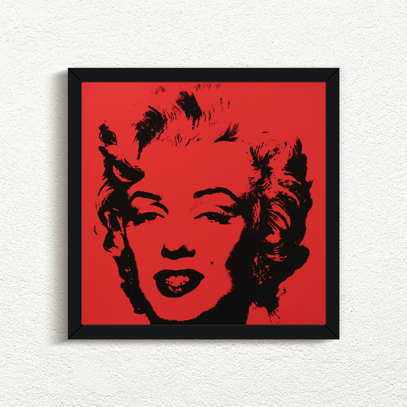 an image of an artwork by andy warhol titled 'Golden Marilyn 43' in black frame. the artwork features a black stencilled image of the face of marilyn monroe on a red background. this is a sunday b morning print