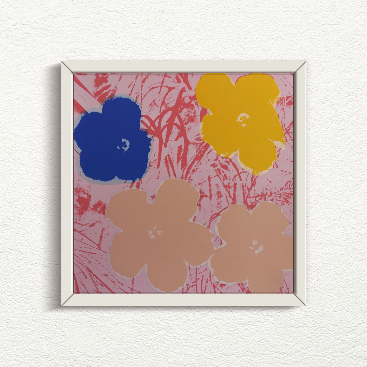 this is an image of a sunday b morning print after the andy warhol artwork 'flowers 11:70' in a white frame. the artwork features a pink grassy background and four flowers, in blue, yellow, and cream colours. this is a sunday b morning print for sale