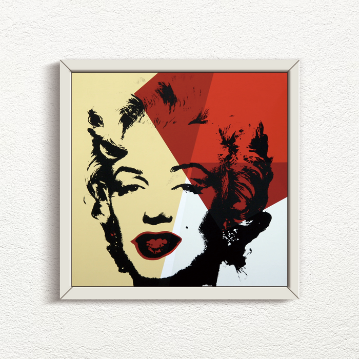 an image of an artwork by andy warhol titled Golden Marilyn 42 in white frame. the artwork features a black stencilled image of marilyn monroe's face on a background of gold, red, and white. this is a sunday b morning print