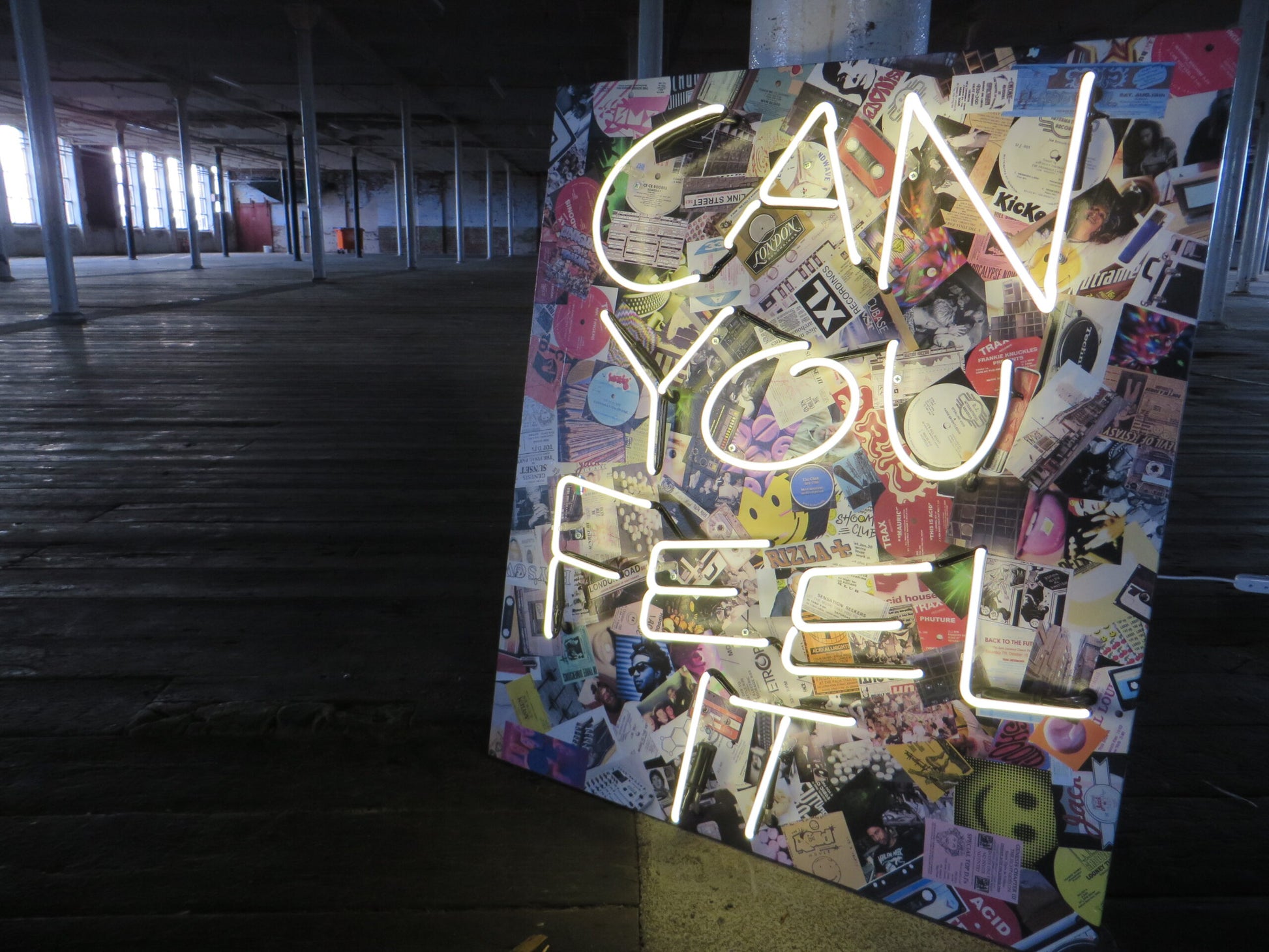 Immerse your space in the iconic 1987/1988 acid house scenes with Tony Spink's Can You Feel It. This one-of-a-kind artwork features white neon on a wooden panel adorned with a collage depicting memorabilia from the acid house era. Measuring 70 x 80 cm, this original masterpiece is a unique fusion of white neon art and nostalgic design. Elevate your space with this distinctive neon artwork, capturing the essence of a bygone musical era.