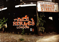 Embrace the vibrancy of urban life with this captivating original artwork by renowned urban artist DS. "Hermes London (Orange)" is a masterful blend of orange spray paint and hand-cut stencils, capturing the essence of the iconic Hermes Street in London, a neighborhood undergoing rapid transformation. This exclusive piece, hand-signed by the artist, is a true gem for art collectors seeking to add a touch of authenticity and urban energy to their collection.