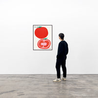 a photo of a david shrigley art print in a black frame, hung on a white wall in a viewing space, with a single spectator to the right of the framed piece.. the print features two large images of the outside of a tomato as well as the inside of a tomato, with small text in the top left stating 'IF YOU DON'T LIKE TOMATOES', and more small text in the bottom right corner stating 'YOU CAN FUCK OFF'. david shrigley prints david shrigley posters david shrigley art