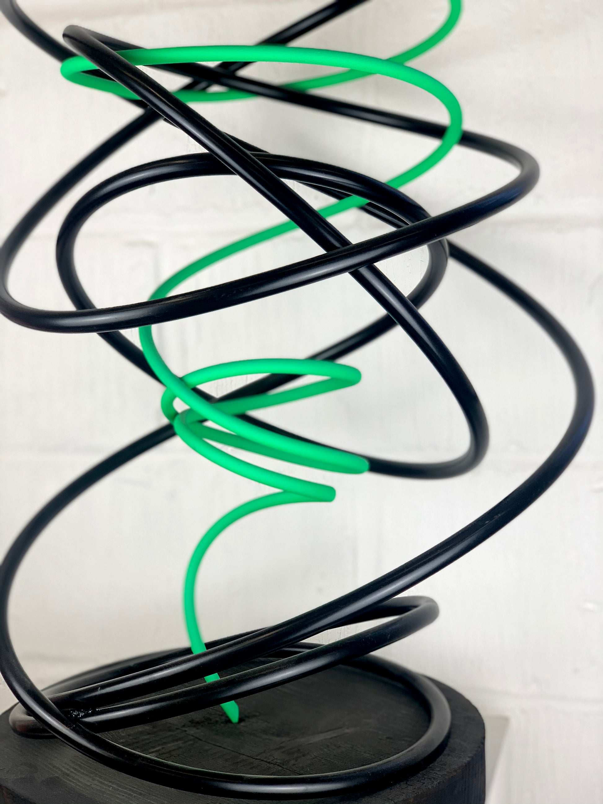 Mark Beattie's Green in Black Spiral, an extraordinary sculpture crafted from painted copper on a burnt plinth. Measuring 68 x 45 x 45 cm