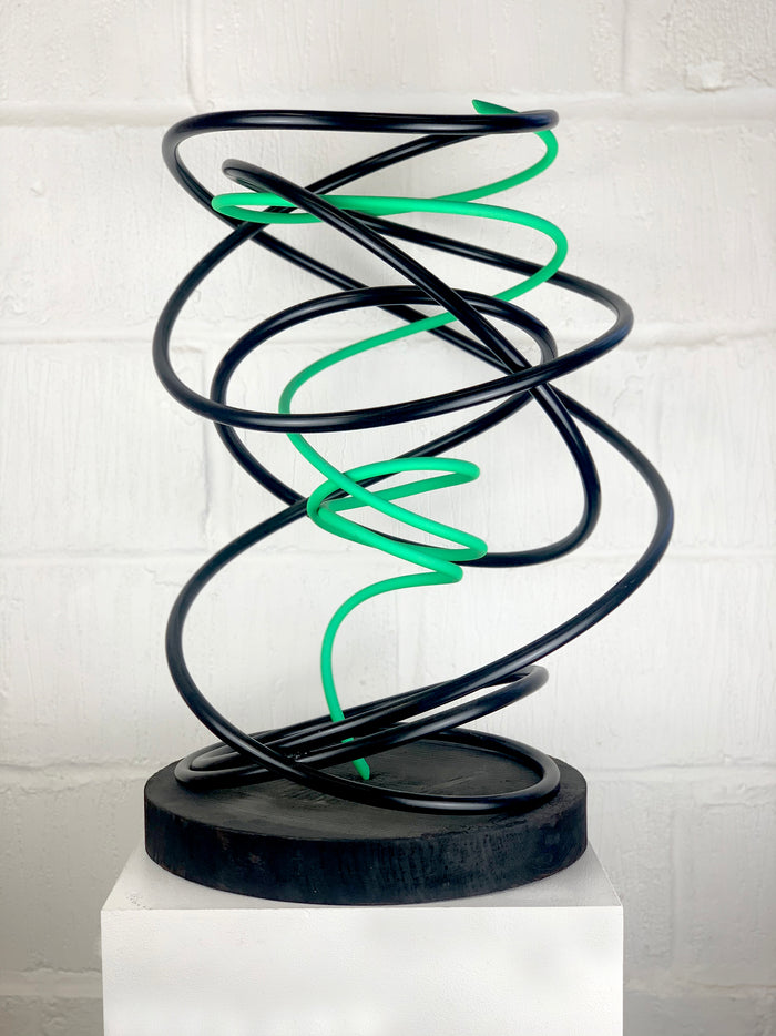 Mark Beattie's Green in Black Spiral, an extraordinary sculpture crafted from painted copper on a burnt plinth. Measuring 68 x 45 x 45 cm