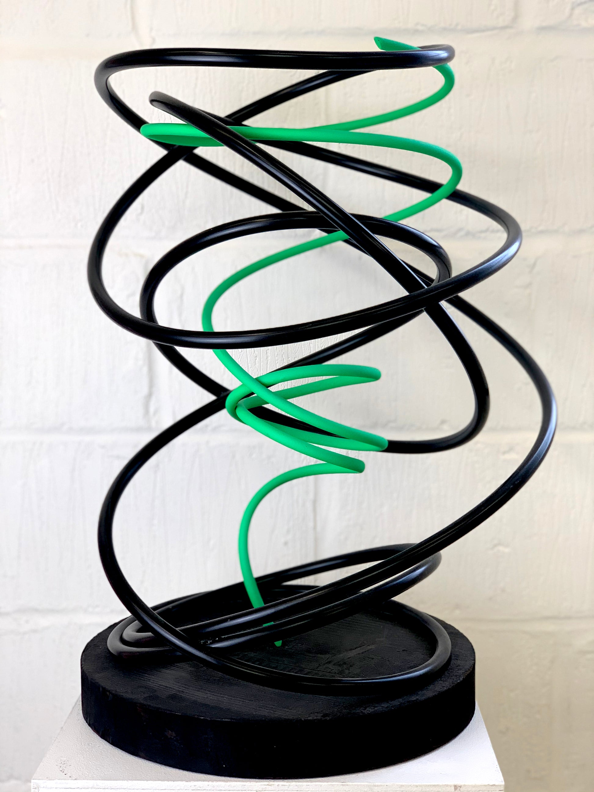 Mark Beattie's Green in Black Spiral, an extraordinary sculpture crafted from painted copper on a burnt plinth. Measuring 68 x 45 x 45 cm