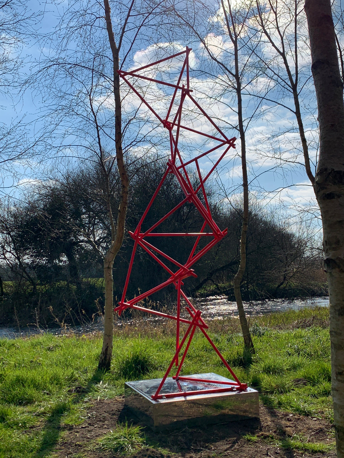 a unique blend of painted copper & LED rope light on a mirror-polished stainless steel plinth