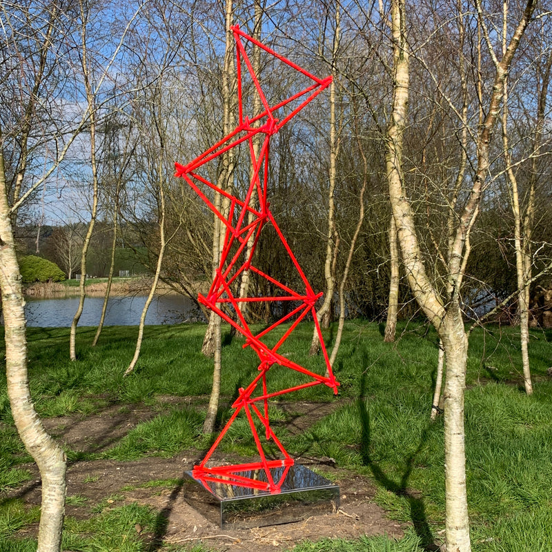 a unique blend of painted copper & LED rope light on a mirror-polished stainless steel plinth