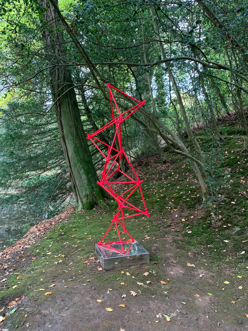 a unique blend of painted copper & LED rope light on a mirror-polished stainless steel plinth