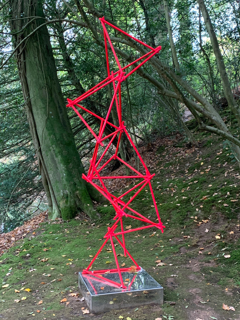 a unique blend of painted copper & LED rope light on a mirror-polished stainless steel plinth