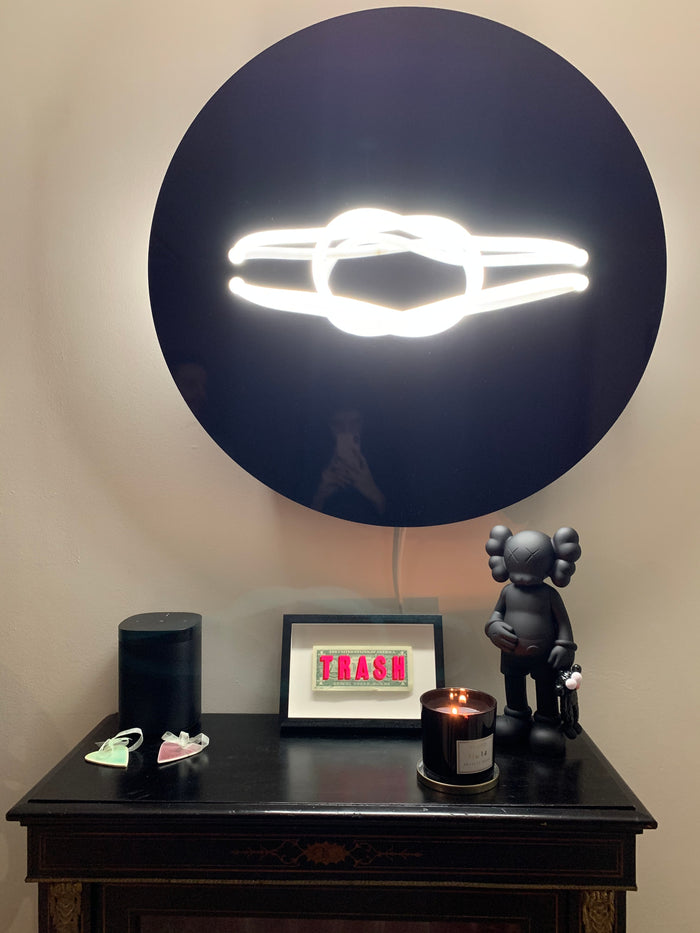 Elevate your space with Mark Beattie's limited edition Love Knot LED Sculpture. Measuring 80cm in diameter and 16cm in depth, this unique masterpiece on Dibond creates a captivating play of light. Choose from exclusive editions in Pink, Blue, and Red to bring contemporary elegance to your collection