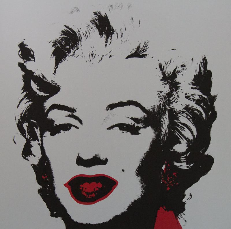 an image of an artwork titled 'golden marilyn 36' by andy warhol. the artwork features a stencilled image of marilyn monroe's face in black on a grey background, with red pops of colour around the mouth and to the right of the face. this is a sunday b morning print