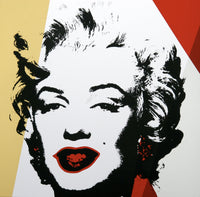 image of an artwork by andy warhol titled 'golden marilyn 37'. the artwork features a stencilled image of marilyn monroe's face in black, on a background of white, red, and gold. this is a sunday b morning print