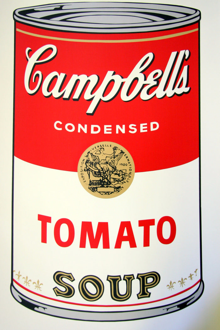 image of andy warhol artwork titled 'campbells tomato soup'. the artwork features a large image of a soup can in a cartoon-like, art pop style, featuring the colours red, grey, white, black, and gold. the can reads 'campbells condensed tomato soup'. this is a sunday b morning print 