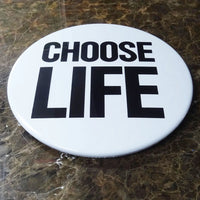 Choose Life Giant 3d Badge by Tape Deck Art resting against a wall 