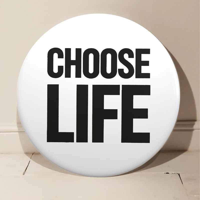 Choose Life Giant 3d Badge by Tape Deck Art resting against a wall 