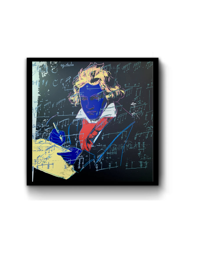 an image of an andy warhol artwork titled 'beethoven 390' in a black frame. the image features beethoven colourised with a royal blue face, yellow hair and writing equipment, and a red scarf. the background is black, and there is an overlay of blue musical notation. this is a sunday b morning print