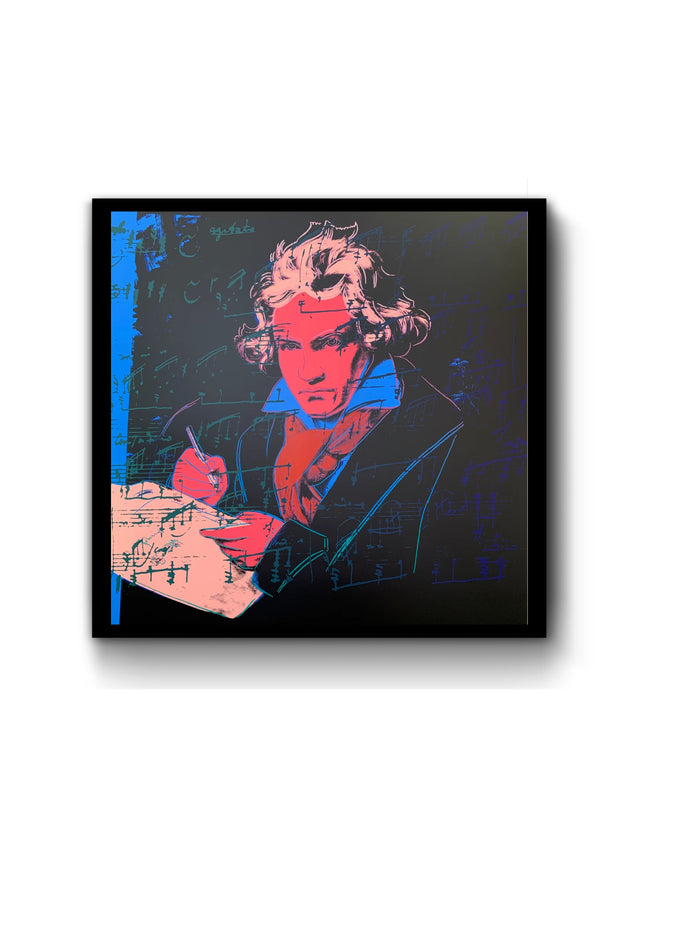 an image of the andy warhol artwork titled 'beethoven 392' in a black frame. the image features a colourised image of beethoven in the centre, with red skin, yellow hair and writing equipment, a blue shirt and red scarf. the background is mostly black, with some blue at the left side. there is overlayed musical notation in both green and blue. this is a sunday b morning print