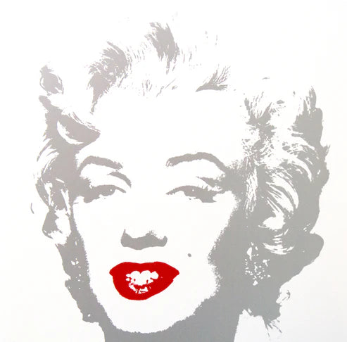 an image of an artwork by andy warhol titled 'golden marilyn 35'. the artwork features a stencilled image of marilyn monroe's face in silver atop of a white background. the only pop of colour is on monroe's lips, which are in red. this is a sunday b morning print