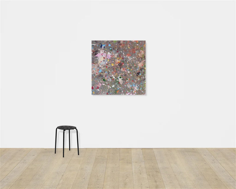 image of artwork hung on plain background. abstract artwork featuring many colourful paint splodges on a grey background