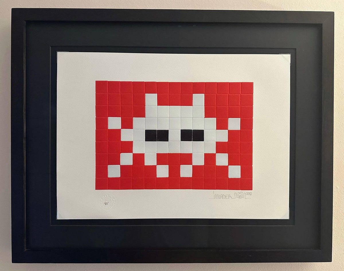 Invader Invasion red print in a black box frame 