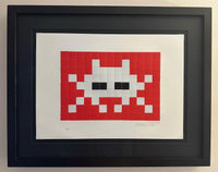 Invader Invasion red print in a black box frame 