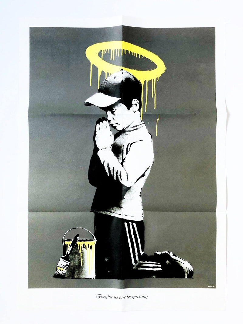 an image of an artwork by Banksy titled 'Forgive Us Our Trespassing'. The artwork features a stencilled image of a young boy in sportswear kneeling down and praying, with a yellow paintbucket in front of him, and a yellow halo painted on the wall above his head. this is a Banksy print for sale