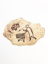 This artwork by Banksk titled Peckham Rock contain a cave painting of a human pushing a shopping trolley whilst huniting a boar which has two arrows in it providing satirical humour 