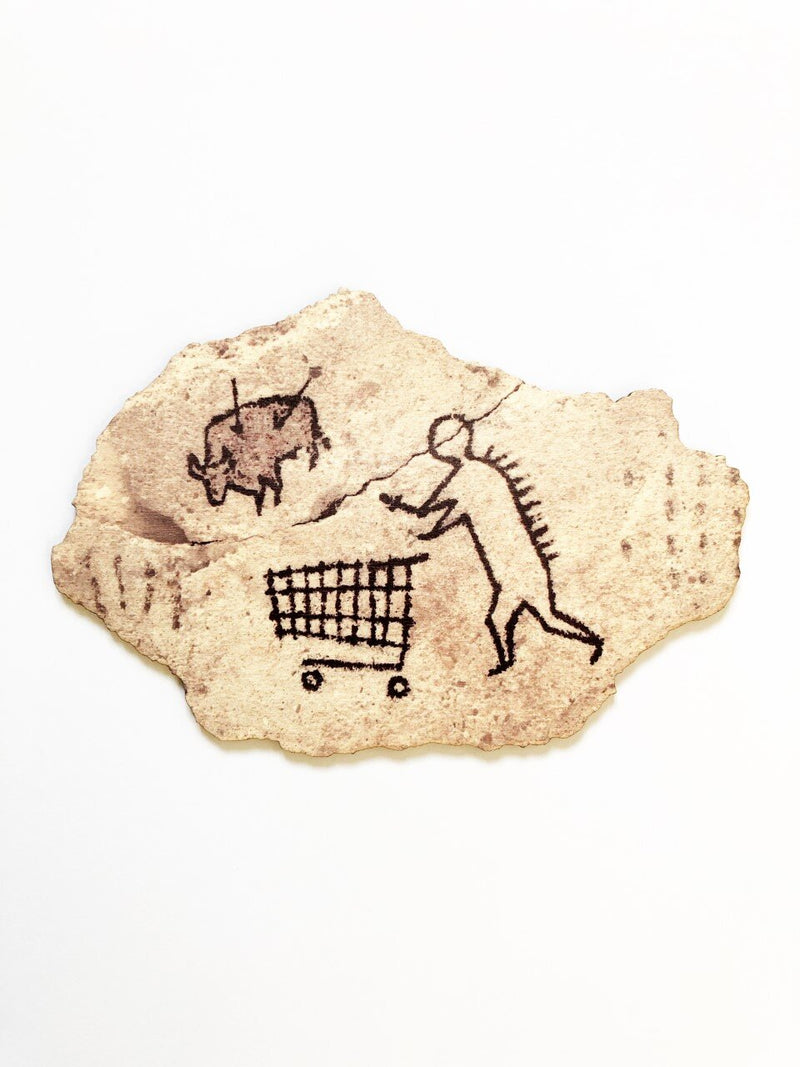 This artwork by Banksk titled Peckham Rock contain a cave painting of a human pushing a shopping trolley whilst huniting a boar which has two arrows in it providing satirical humour 