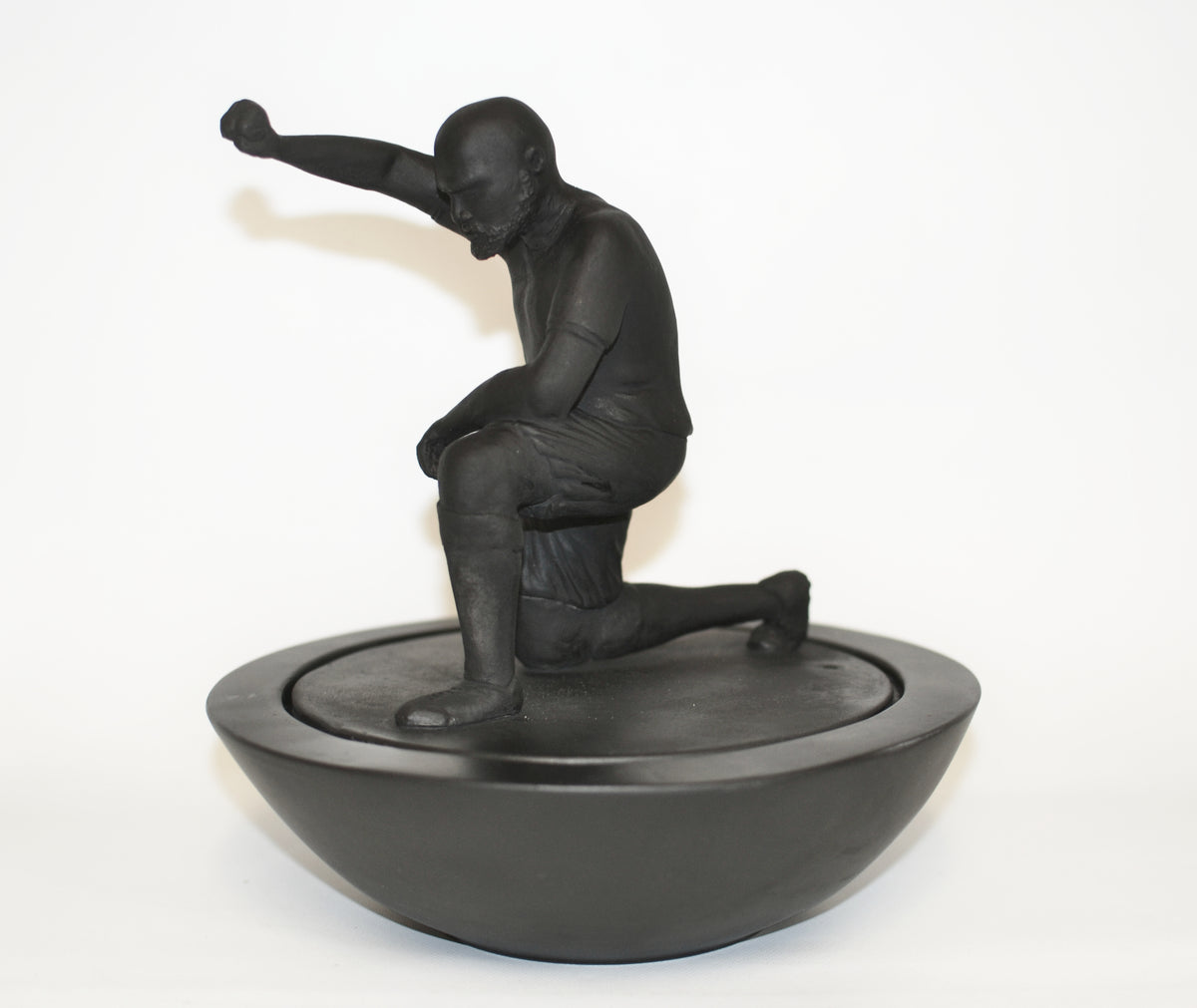 Sculpture in black from the artist Simon Shepherd based of the old football game subbuteo 